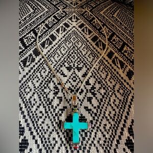 Chunky turquoise cross on silver chain.